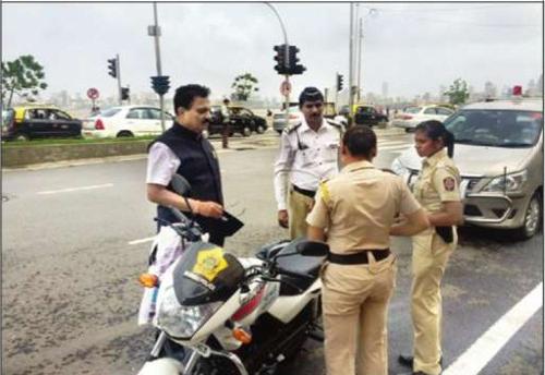 Traffic Cops Fined for Riding without Helmets
